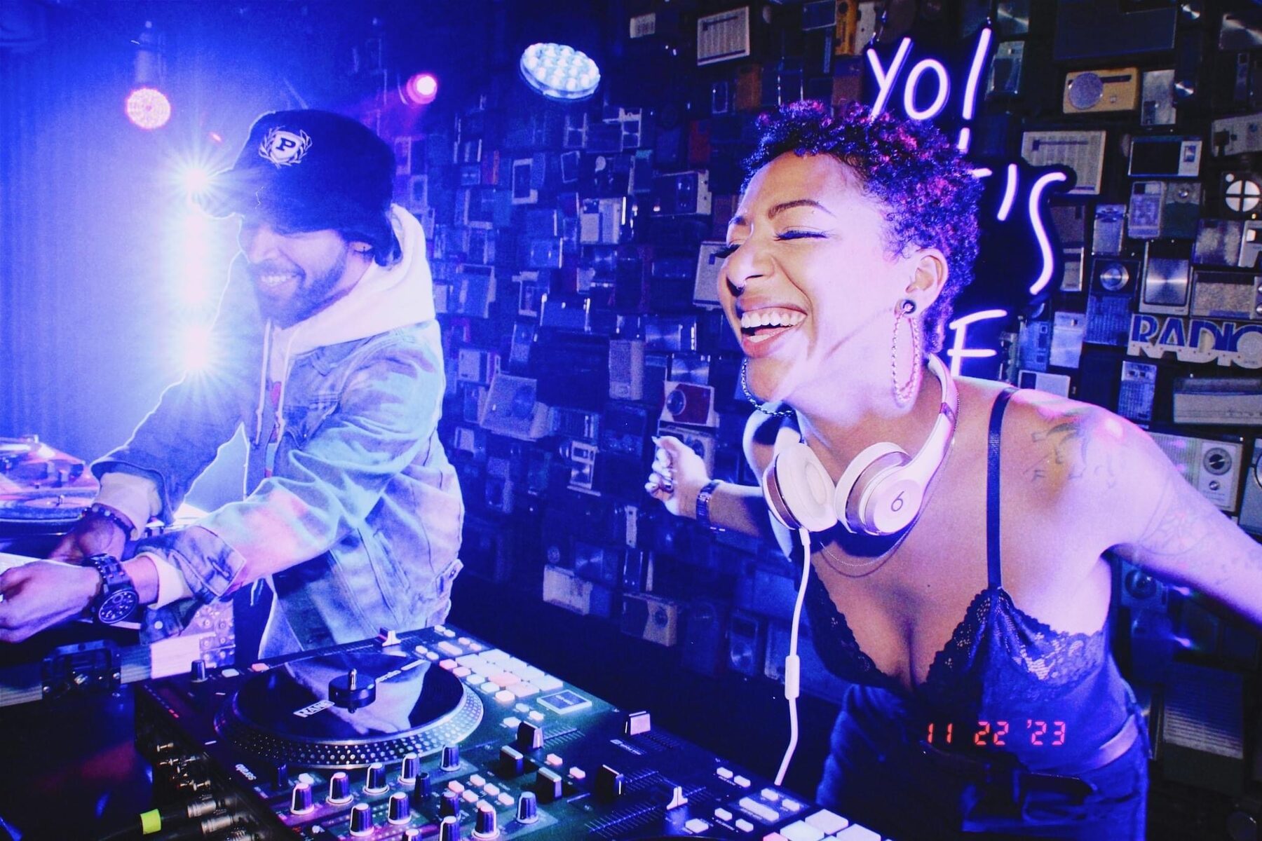 DJ Mahay dancing at the booth with a friend